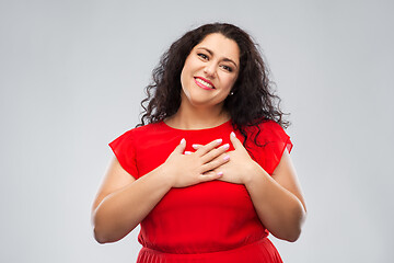 Image showing happy woman holding hands on chest or heart