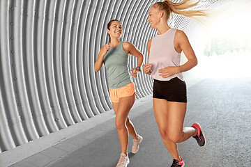 Image showing young women or female friends running outdoors