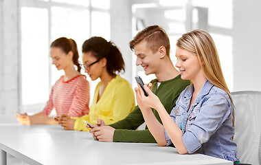 Image showing happy high school students with smartphones