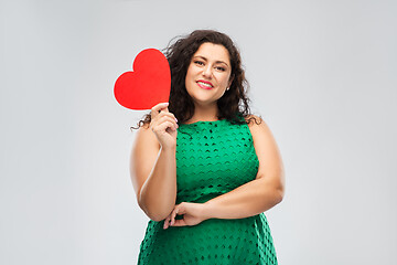 Image showing happy woman in green dress holding red heart