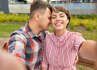 Image showing happy couple in park taking selfie outdoors