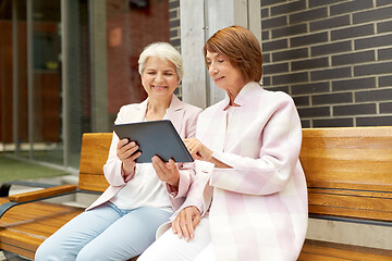 Image showing senior women with tablet computer in city