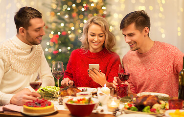 Image showing friends with cellphone celebrate christmas at home