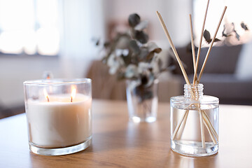 Image showing aroma reed diffuser, burning candle and perfume