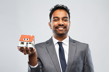 Image showing indian man realtor with house model and folder