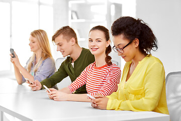 Image showing happy high school students with smartphones