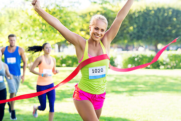 Image showing happy young female runner on finish winning race