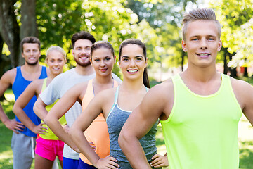 Image showing group of happy friends or sportsmen at summer park