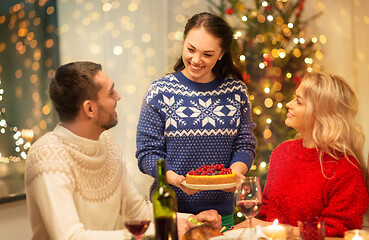 Image showing happy friends having christmas dinner at home