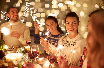 Image showing happy friends celebrating christmas at home feast