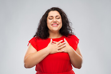 Image showing happy woman holding hands on chest or heart