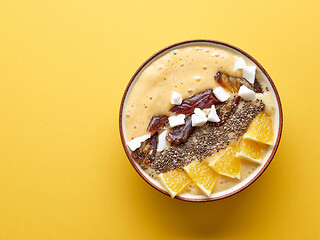 Image showing breakfast smoothie bowl on yellow background