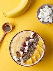 Image showing breakfast smoothie bowl on yellow background