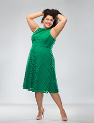 Image showing happy woman in green dress over posing