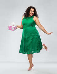 Image showing happy woman in green dress holding gift box