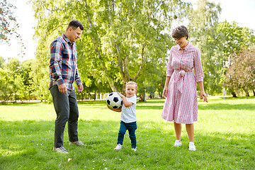 Image showing happy family playing soccer at summer park