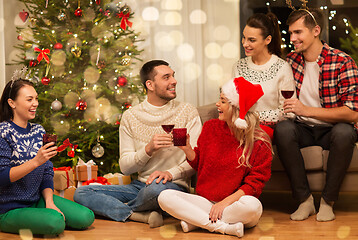 Image showing friends celebrating christmas and drinking wine