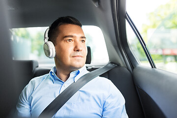 Image showing passenger in headphones listening to music in car