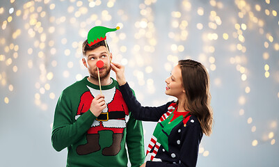 Image showing couple with christmas party props in ugly sweaters