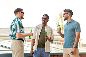 Image showing happy male friends drinking beer at rooftop party