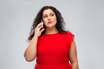 Image showing woman in red dress calling on smartphone