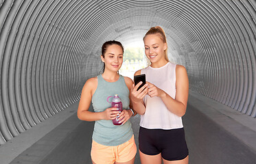 Image showing women or female friends with smartphone and flask