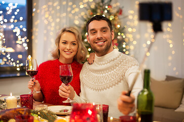 Image showing couple taking picture by selfie stick at christmas