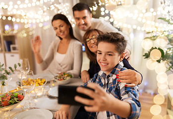 Image showing family having dinner party and taking selfie