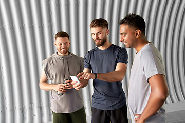 Image showing sporty men or friends with smartphone outdoors