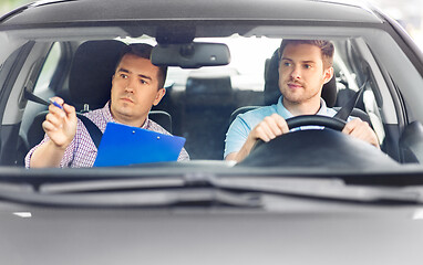 Image showing car driving school instructor and young driver