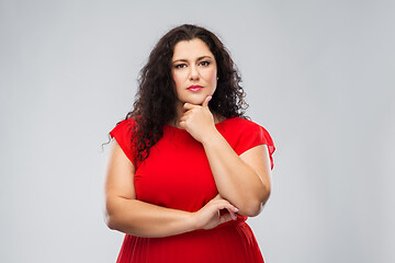 Image showing serious woman in red dress thinking