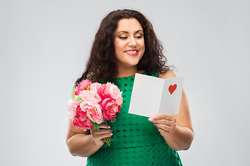 Image showing happy woman with flower bunch and greeting card