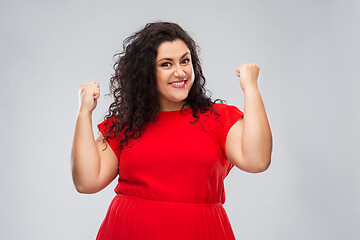 Image showing happy woman in red dress celebrating success