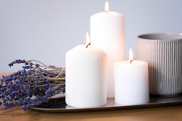 Image showing candles, tea in mug and lavender flowers on table