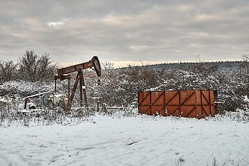 Image showing Oil well on a winter landscape