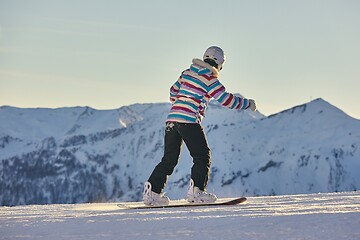 Image showing Female snowboarder in the Alps