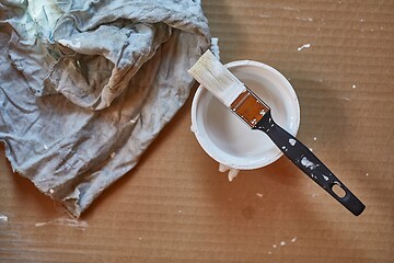 Image showing Paint brush on a can of white wall paint