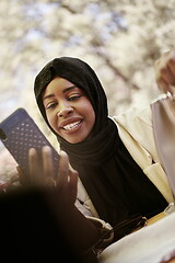 Image showing african woman using smartphone wearing traditional islamic clothes