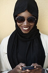 Image showing african woman using smartphone wearing traditional islamic clothes