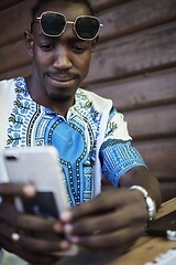 Image showing native african black man using smart phone