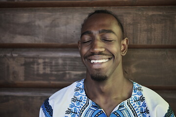 Image showing portrait of a smiling young african man wearing traditioinal clothes