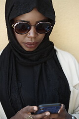 Image showing african woman using smartphone wearing traditional islamic clothes