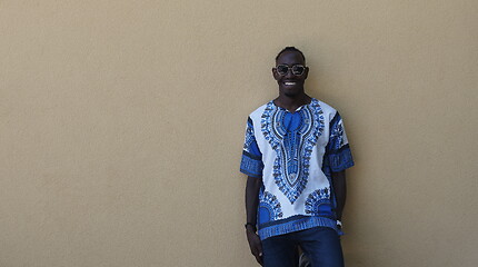 Image showing portrait of a smiling young african man wearing traditioinal clothes