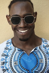 Image showing portrait of a smiling young african man wearing traditioinal clothes