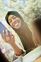 Image showing african woman using smartphone wearing traditional islamic clothes