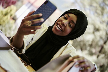 Image showing african woman using smartphone wearing traditional islamic clothes