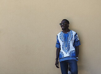 Image showing portrait of a smiling young african man wearing traditioinal clothes