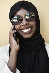 Image showing african woman using smartphone wearing traditional islamic clothes