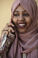 Image showing african woman using smartphone wearing traditional islamic clothes