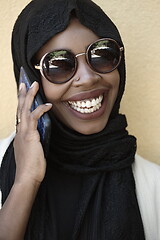 Image showing african woman using smartphone wearing traditional islamic clothes